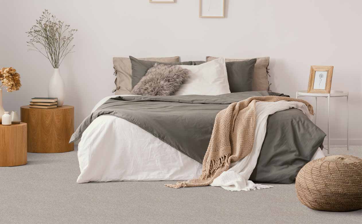 Bedroom with bed and grey carpeted floor