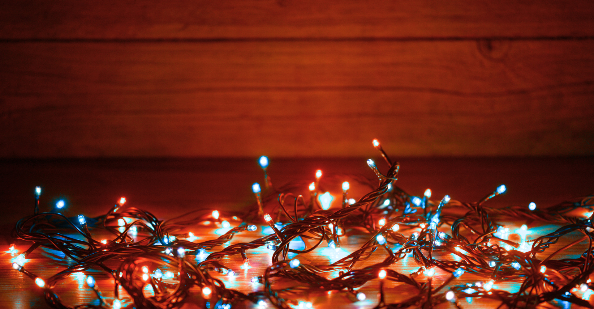 Dad pushing Daughter in Cardboard Box on Hardwood Floors